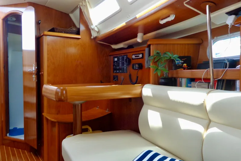 Slide: The Image of Interior of 2004 Jeanneau Sun Odyssey 37 sailboat with wooden finish and seating area. - 24