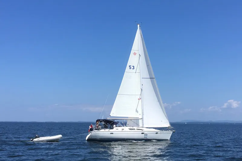 The Image of 2004 Jeanneau Sun Odyssey 37 sailing on open sea under clear blue sky. - 3