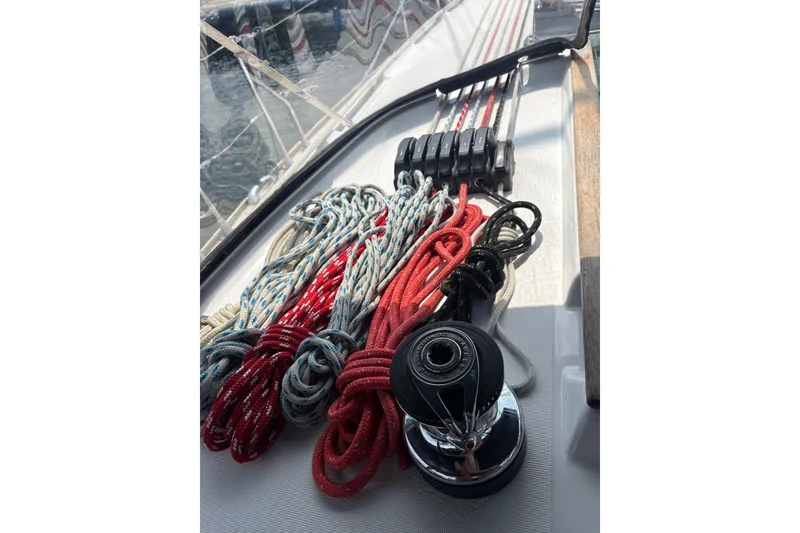 Slide: The Image of Deck of 2004 Jeanneau Sun Odyssey 37 with colorful ropes and winch. - 13