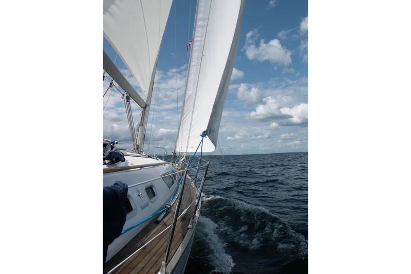 Slide: The Image of Sailing Jeanneau Sun Odyssey 37, 2004 model, on open sea under clear skies. - 6