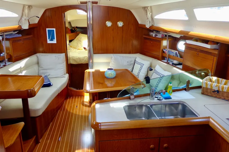 Slide: The Image of Interior of 2004 Jeanneau Sun Odyssey 37 sailboat with cozy seating and wooden finishes. - 17