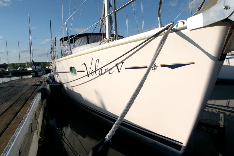 Slide: The Image of 2004 Jeanneau Sun Odyssey 37 sailboat docked at marina, side view with clear sky. - 1