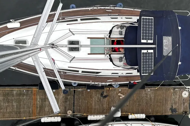 Slide: The Image of Overhead view of a 2004 Jeanneau Sun Odyssey 37 sailboat docked, featuring solar panels. - 37
