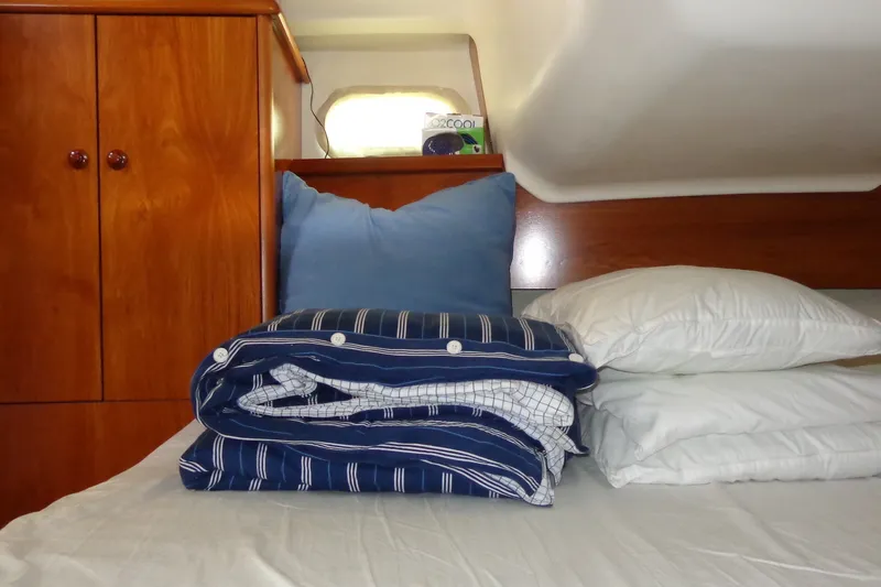 Slide: The Image of Cozy cabin interior of 2004 Jeanneau Sun Odyssey 37 with neatly arranged bedding. - 25