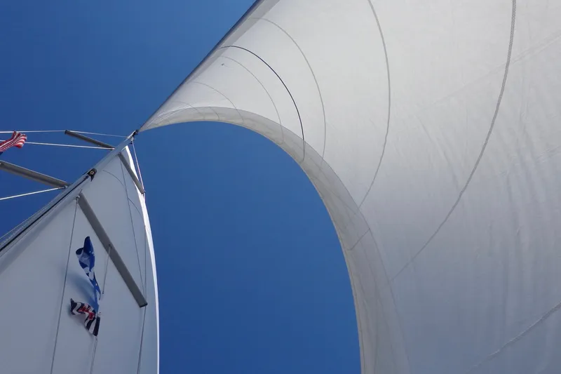 Slide: The Image of Sails of a 2004 Jeanneau Sun Odyssey 37 against a clear blue sky. - 5