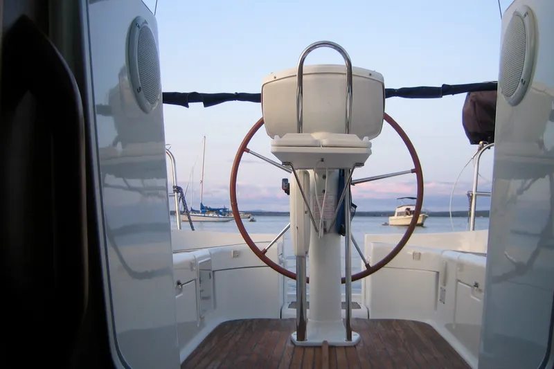 Slide: The Image of Cockpit view of 2004 Jeanneau Sun Odyssey 37 sailboat with scenic harbor background. - 11