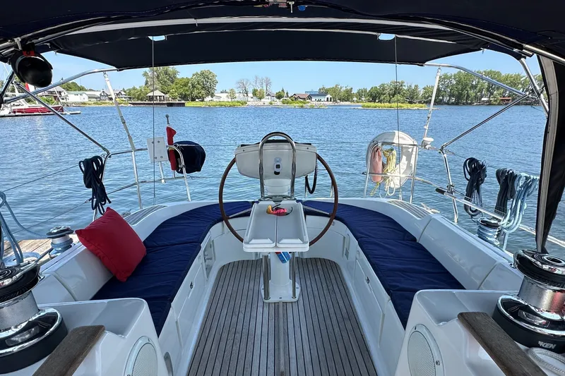 Slide: The Image of Cockpit of 2004 Jeanneau Sun Odyssey 37 sailboat with scenic waterfront view. - 12