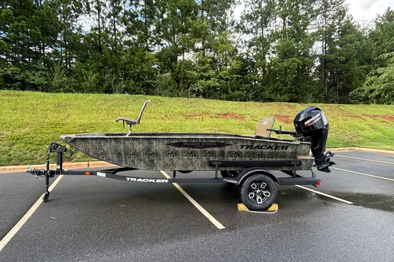 The Image of 2026 Tracker Grizzly 1650 T Prairie Wings Edition boat on trailer, parked outdoors. - 0
