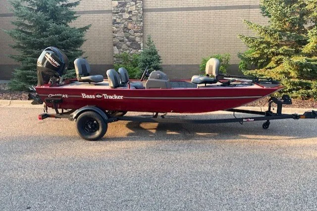 The Image of 2026 Tracker Bass Tracker Classic XL boat on trailer, parked outdoors. - 0
