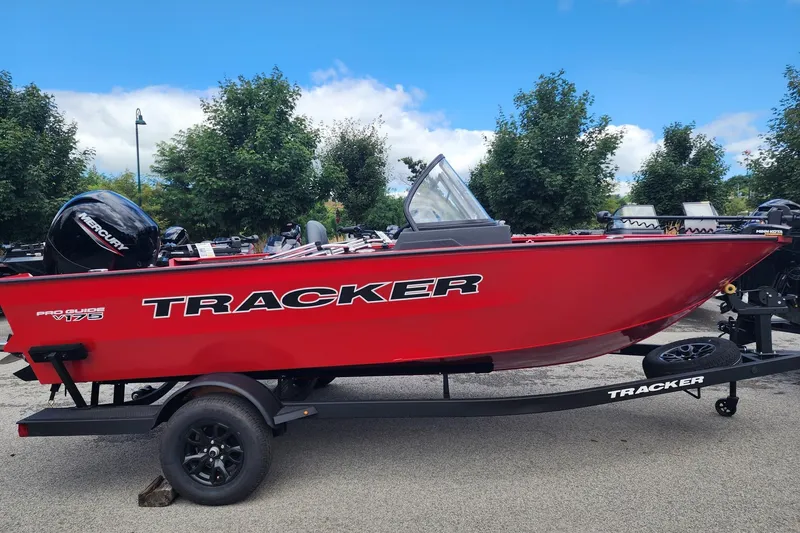 The Image of 2026 Tracker Pro Guide V-175 WT boat in vibrant red on a trailer, outdoors. - 0