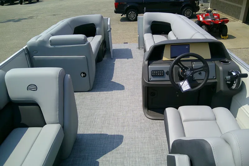 Slide: The Image of 2026 Sun Tracker Party Barge 20 DLX interior with plush seating and modern helm. - 93