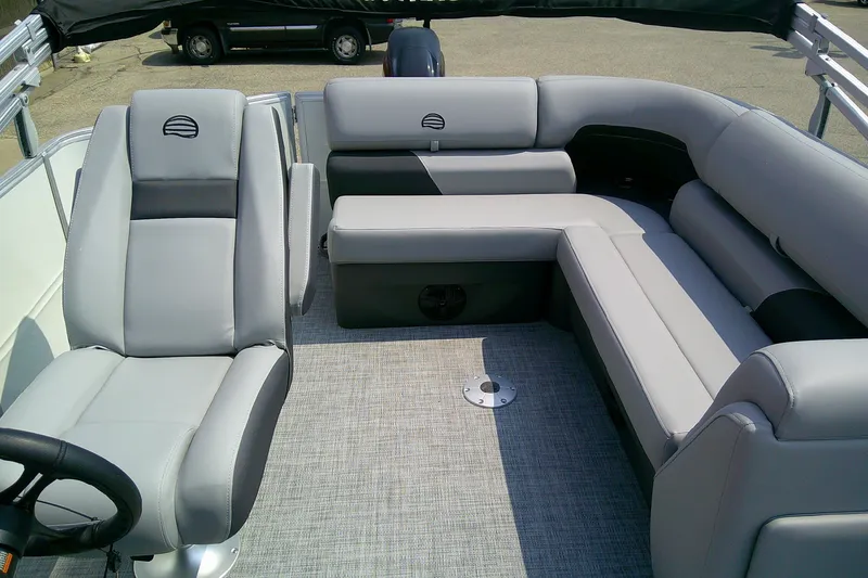 Slide: The Image of 2026 Sun Tracker Party Barge 20 DLX interior with plush gray seating and modern design. - 92