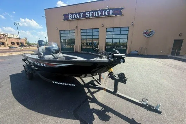 The Image of 2026 Tracker Super Guide V-16 SC boat parked outside a boat service center. - 0