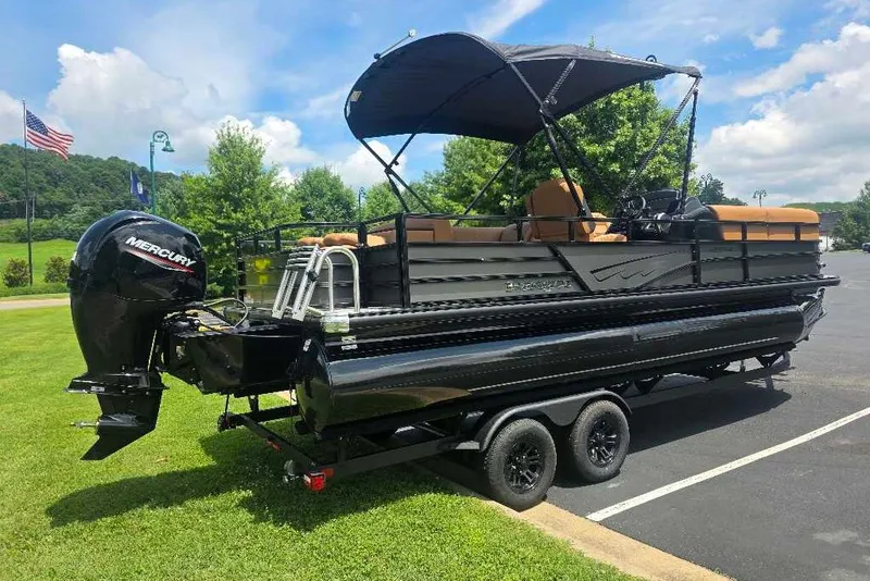Slide: The Image of 2026 Ranger 220FC pontoon boat with Mercury engine on trailer, parked outdoors. - 2
