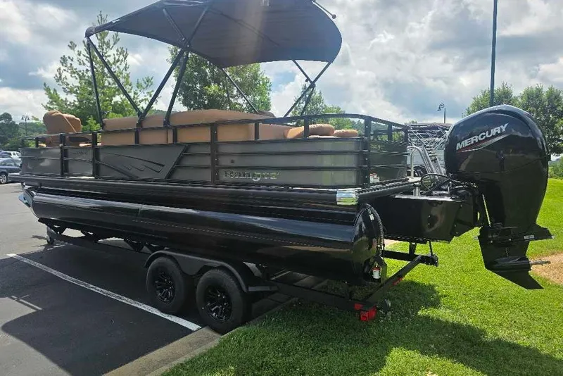 Slide: The Image of 2026 Ranger 220FC pontoon boat with Mercury outboard engine, parked on a trailer. - 3