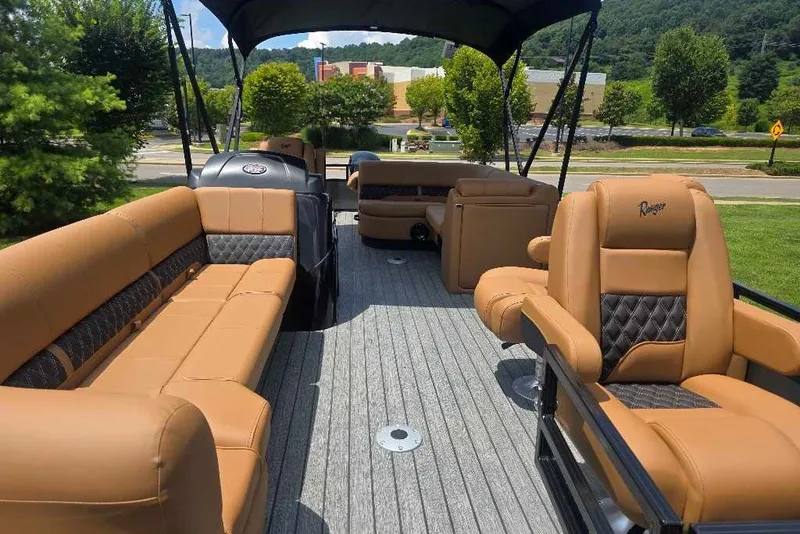 Slide: The Image of Luxurious 2026 Ranger 220FC boat interior with tan leather seating and scenic background. - 5