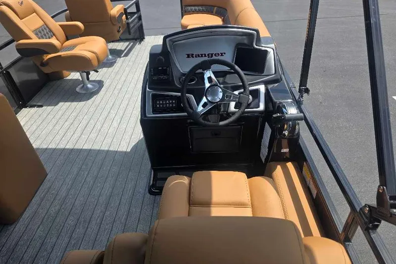 Slide: The Image of Interior of 2026 Ranger 220FC boat with tan seating and steering console. - 7