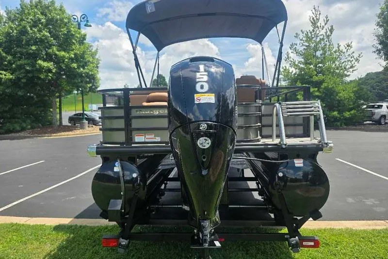Slide: The Image of 2026 Ranger 220FC boat with 150 horsepower engine in a parking lot. - 4