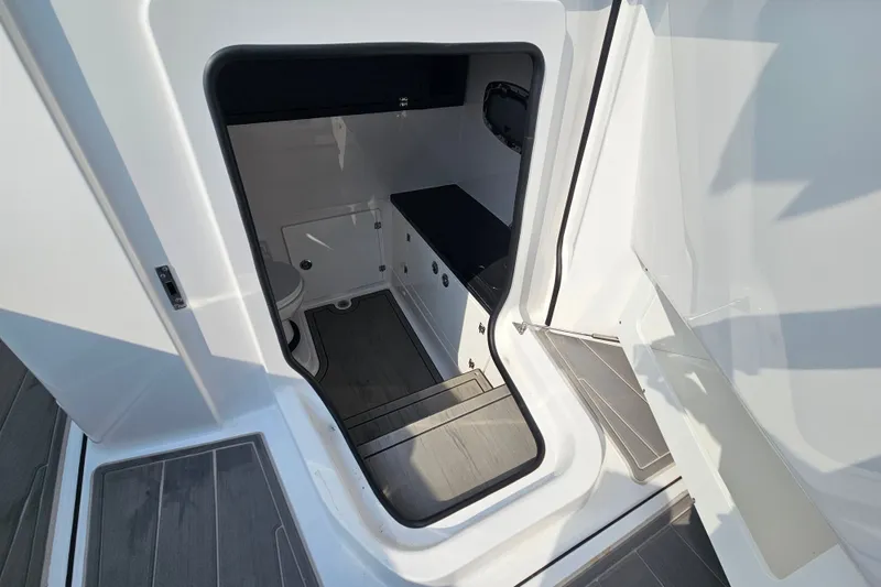 Slide: The Image of Interior view of 2026 Monterey Elite 30 OB boat cabin with modern amenities. - 29