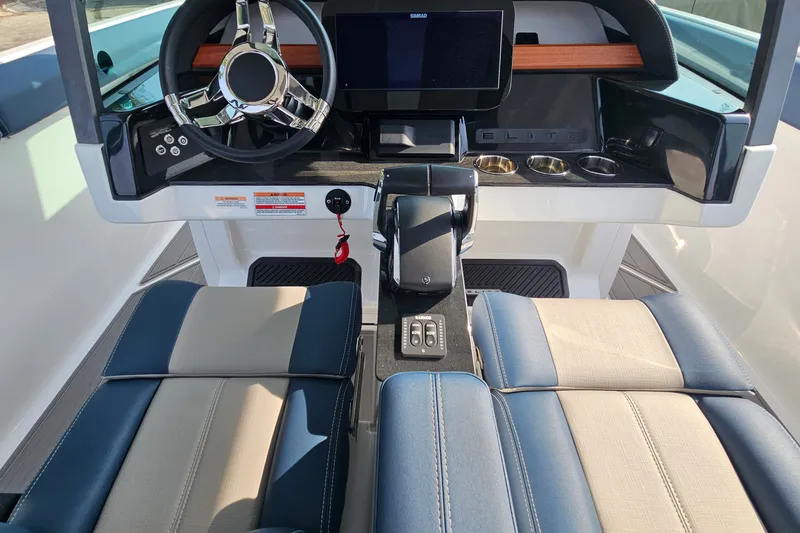 Slide: The Image of 2026 Monterey Elite 30 OB boat cockpit with modern steering and control panel. - 23