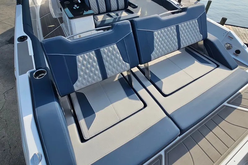 Slide: The Image of 2026 Monterey Elite 30 OB boat with luxurious blue and gray seating. - 15