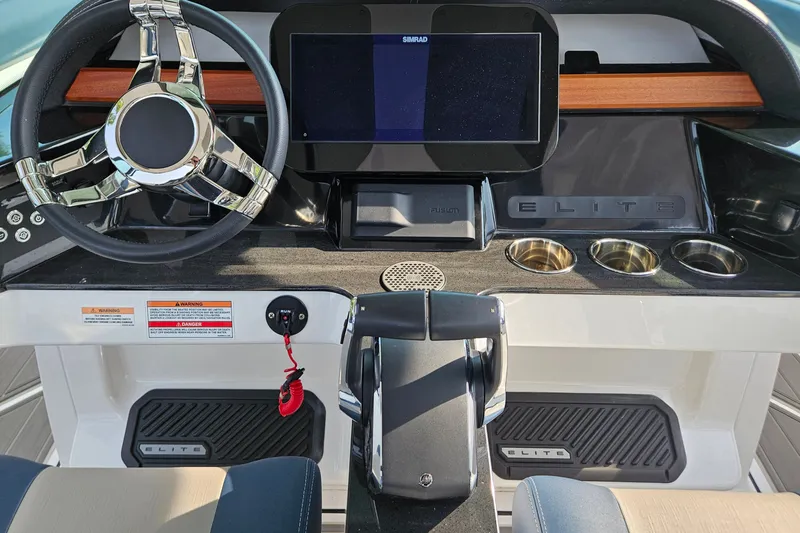 Slide: The Image of 2026 Monterey Elite 30 OB dashboard with steering wheel, touchscreen, and cup holders. - 32