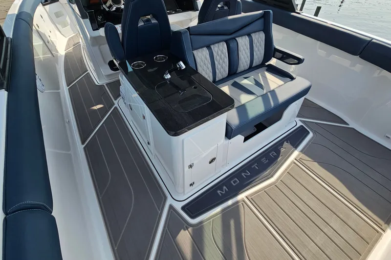 Slide: The Image of 2026 Monterey Elite 30 OB boat interior with luxurious seating and sleek design. - 19