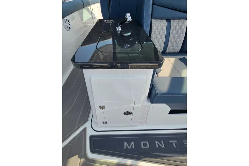 Slide: The Image of Interior of 2026 Monterey Elite 30 OB boat with sleek seating and countertop. - 20