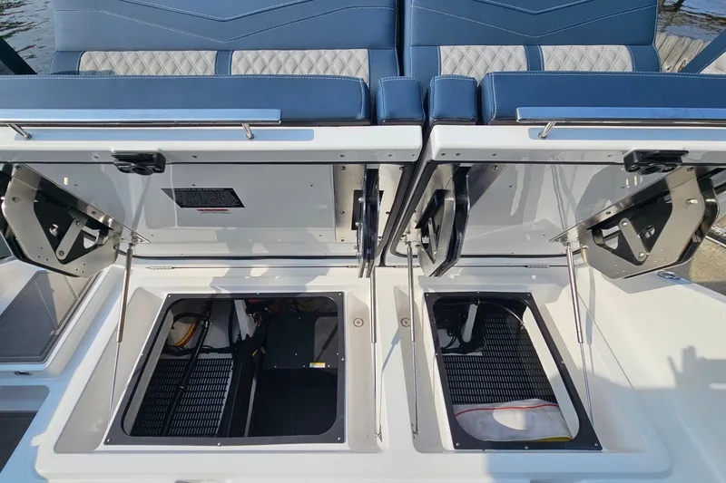 Slide: The Image of Open storage compartments on a 2026 Monterey Elite 30 OB boat, showcasing interior features. - 18