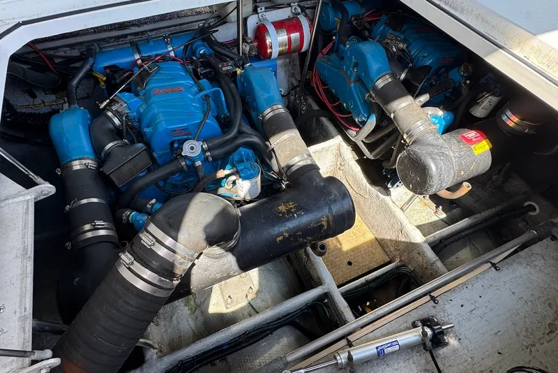 Slide: The Image of Engine compartment of a 1999 Silverton 351 Sedan with blue marine engines. - 19