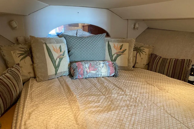 Slide: The Image of Cozy cabin interior of 1999 Silverton 351 Sedan with decorative pillows and bedding. - 9