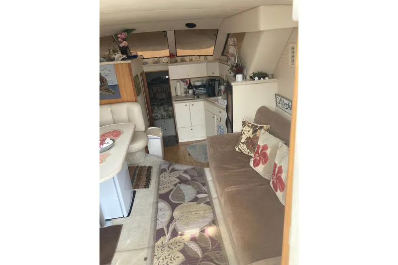 Slide: The Image of Interior of a 1999 Silverton 351 Sedan yacht with cozy seating and kitchenette. - 6