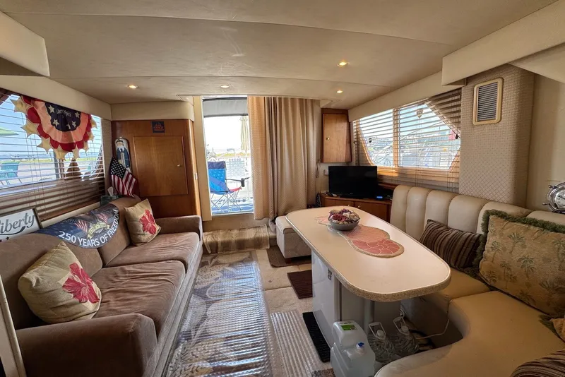 Slide: The Image of Interior of a 1999 Silverton 351 Sedan yacht with cozy seating and decor. - 18