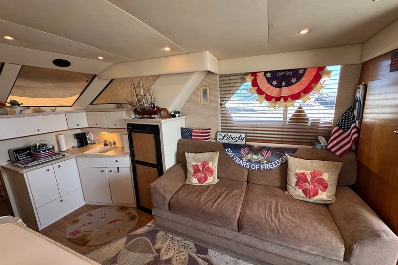 Slide: The Image of Interior of a 1999 Silverton 351 Sedan with patriotic decor and cozy seating area. - 14