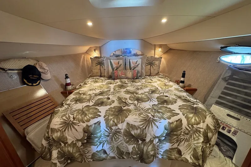 Slide: The Image of Cozy 1999 Silverton 351 Sedan cabin with tropical bedding and nautical decor. - 17