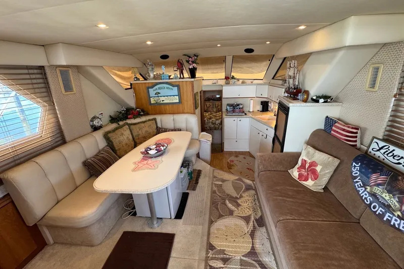 Slide: The Image of Interior of a 1999 Silverton 351 Sedan yacht with cozy seating and nautical decor. - 12