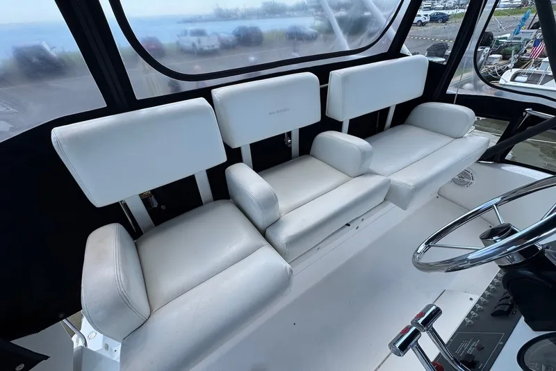 Slide: The Image of Interior seating of a 1999 Silverton 351 Sedan boat with white upholstery. - 9