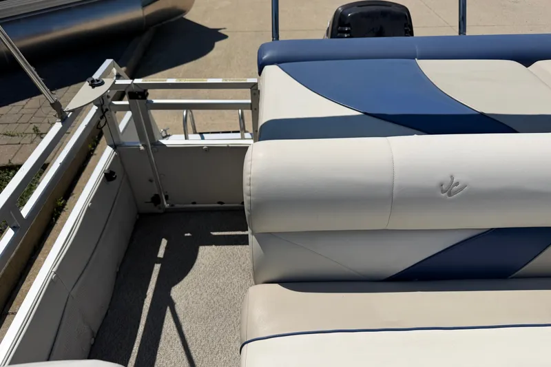 Slide: The Image of 2005 JC 21 NEPTOON TT pontoon boat interior with blue and white seating. - 14