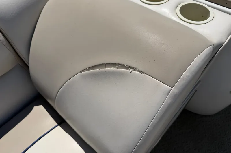 Slide: The Image of Torn upholstery on 2005 JC 21 NEPTOON TT boat seat with cup holders. - 9