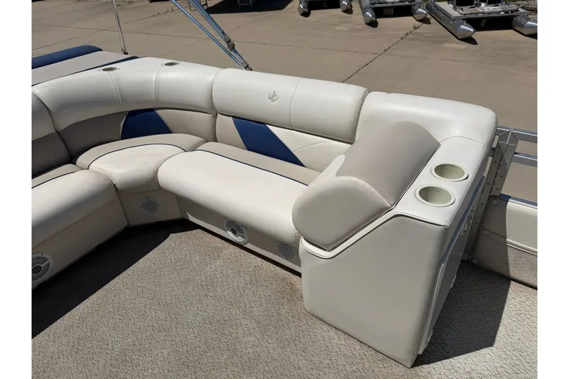 Slide: The Image of 2005 JC 21 NEPTOON TT boat interior with white and blue cushioned seating. - 10