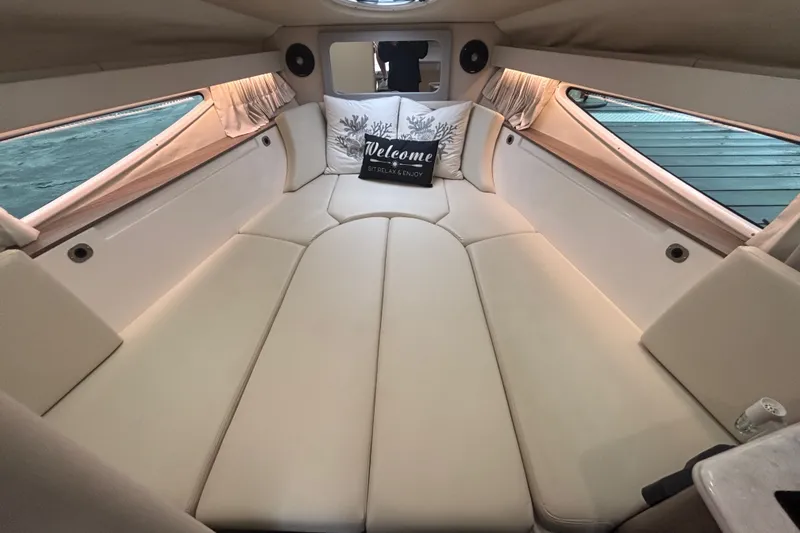 Slide: The Image of Interior of 2019 Regal 28 Express boat with cozy seating and decorative pillows. - 41