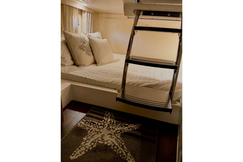 Slide: The Image of Cozy cabin interior of 2019 Regal 28 Express with bed and decorative pillows. - 9