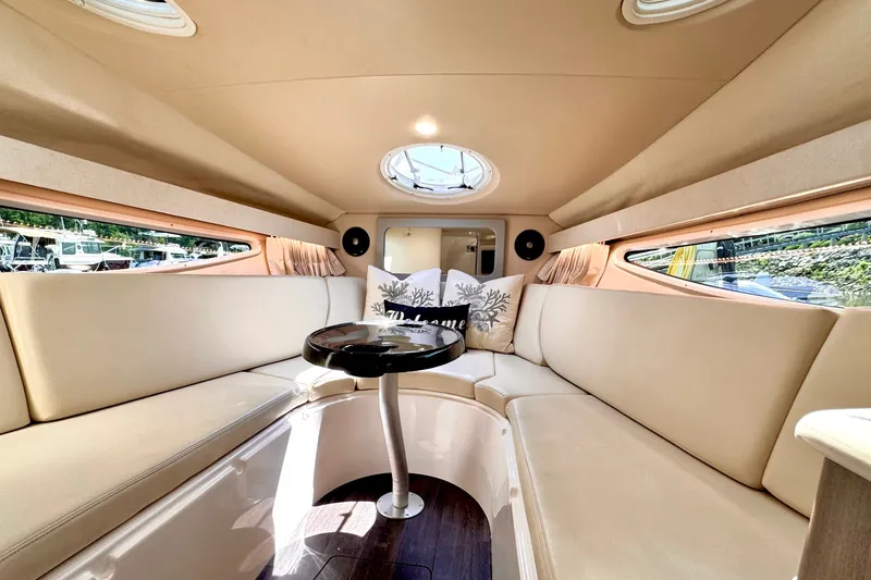 Slide: The Image of Luxurious interior of 2019 Regal 28 Express boat with beige seating and round table. - 8