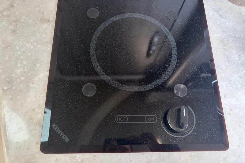 Slide: The Image of Kenyon electric cooktop on Regal 28 Express 2019 boat, featuring a single burner. - 34
