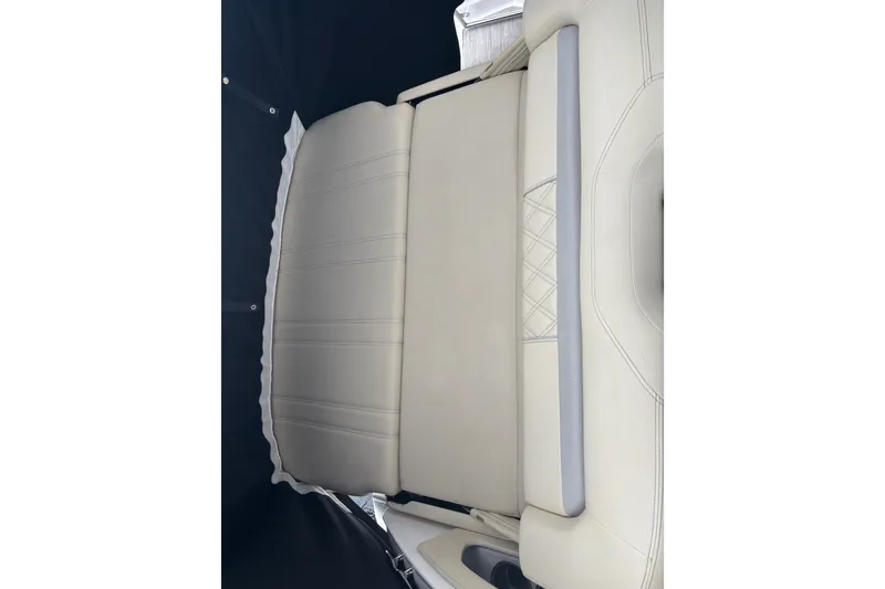 Slide: The Image of 2019 Regal 28 Express boat interior with beige cushioned seating. - 13