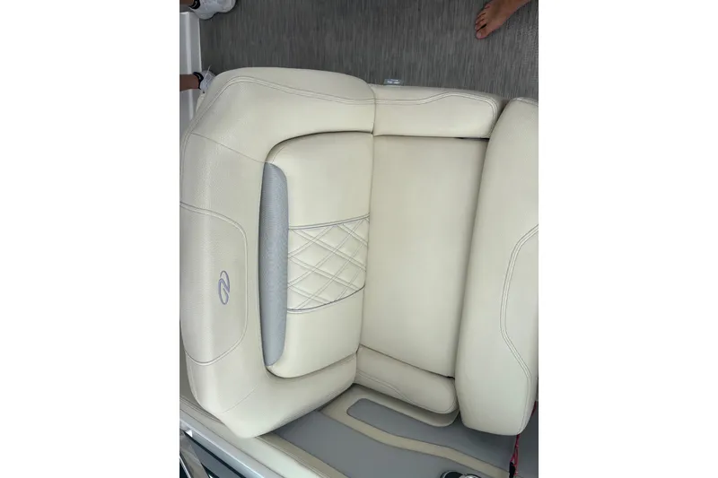 Slide: The Image of Luxurious beige seating on a 2019 Regal 28 Express boat, featuring elegant stitching. - 19