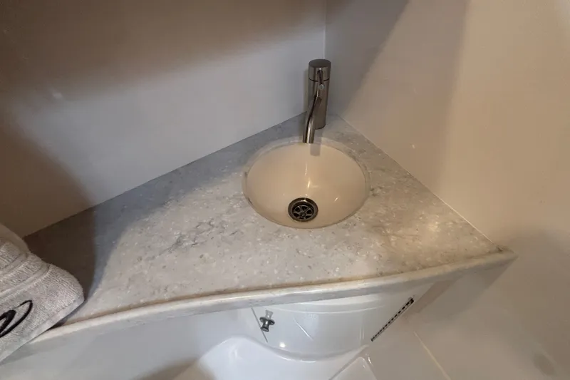 Slide: The Image of Compact bathroom sink in 2019 Regal 28 Express boat, featuring modern faucet and countertop. - 40