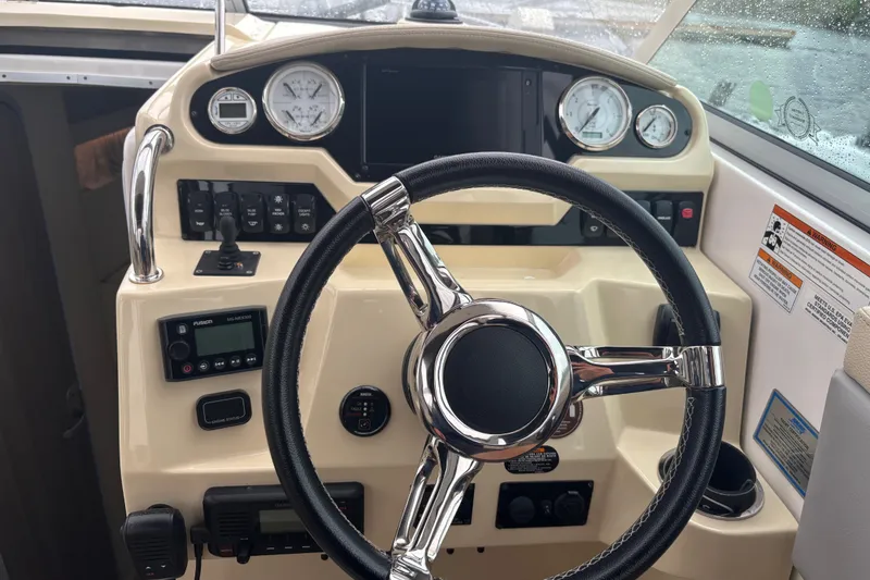 Slide: The Image of 2019 Regal 28 Express boat dashboard with steering wheel and control gauges. - 20