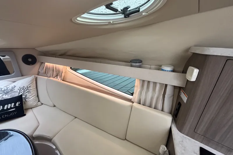 Slide: The Image of Interior of a 2019 Regal 28 Express boat with cozy seating and decor. - 28