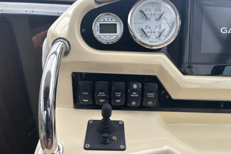Slide: The Image of Control panel of a 2019 Regal 28 Express boat with gauges and switches. - 21